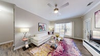 Located in Pensacola, FL, this thoughtfully designed one-bedroom, one-bathroom residence offers a comfortable and functional single-floor layout. The open-concept living room and kitchen area serves as the heart of the home, with the living space showcasing wood-style flooring, crown molding, a ceiling fan, and large windows that invite generous natural light and outdoor views. The galley-style kitchen is well-equipped with white cabinetry, dark countertops, black appliances including a range, refrigerator, microwave, and dishwasher, along with ample storage and a stainless steel sink. The bedroom features carpet flooring, a ceiling fan, and a closet, providing a quiet and restful retreat. A dedicated office space with carpet flooring and a bright window offers an ideal work-from-home setup. The full bathroom includes a white vanity with dark countertops, a large mirror with overhead lighting, and a tub-shower combination with wood-style flooring. A convenient in-unit laundry room houses a full-size washer and dryer. A hallway connects the rooms cohesively, completing this efficient and well-organized residence.