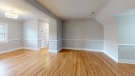 Located at 41 1/2 Malvern Ave in Richmond, Virginia's desirable 23221 zip code, this well-appointed one-bedroom, one-bathroom residence offers a thoughtfully designed single-floor layout. Warm hardwood floors flow seamlessly throughout, complemented by soft gray walls and crisp white trim and baseboards that give the home a clean, cohesive aesthetic.

The living areas are defined by charming vaulted, angled ceilings that add architectural character and a sense of openness. Arched doorways connect rooms gracefully, while multiple windows allow natural light to brighten the interior throughout the day. A dedicated dining room adds functionality beyond the main living space.

The kitchen is a standout, featuring white shaker-style cabinetry with brushed gold hardware, sparkling quartz countertops, a subway tile backsplash, stainless steel appliances including a gas range and dishwasher, and an under-mount sink — all illuminated by under-cabinet lighting and a natural light-filled window.

The spacious bedroom offers generous square footage, angled ceilings, multiple windows, and ample room for furnishings. A dedicated closet and hallway provide practical storage and flow. The bathroom features a tub and shower surround finished in clean white subway tile, maintaining the home's consistent modern aesthetic throughout.