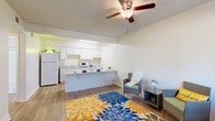 Located at 125 S Dobson Rd in Chandler, AZ, this efficient one-bedroom, one-bathroom unit is thoughtfully laid out across a single floor. The open-concept kitchen and living area serves as the heart of the home, where a peninsula counter separates the two spaces while maintaining a bright, connected feel. The kitchen is outfitted with white cabinetry, ample counter space, a full-size refrigerator, dishwasher, and built-in appliances. Light hardwood-style flooring runs throughout the unit, complementing the neutral wall tones and textured ceilings. Ceiling fans are installed in the main living area and bedroom, promoting airflow and comfort. The living area benefits from a large window that invites natural light and provides outdoor views. The bedroom is a comfortable, well-proportioned room with its own window fitted with vertical blinds and a dedicated ceiling fan. A walk-in closet with built-in shelving provides organized storage space. The full bathroom features a tub/shower combination with a clean, white surround. Additional conveniences include a dedicated laundry area and a hallway that connects all rooms efficiently. The overall ambiance is clean, functional, and well-maintained, making it a practical home in the heart of Chandler.