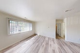 Located at 11650 Plaza Dr in Clio, MI, this single-floor, one-bedroom, one-bathroom unit offers a well-organized and functional layout. The combined living and dining area is bright and open, featuring light wood-style flooring throughout and a large window dressed with vertical blinds that invites generous natural light and outdoor views of the surrounding greenery. The textured ceiling and clean white walls create a neutral, move-in-ready aesthetic.

The kitchen is designed with a peninsula layout, featuring warm wood-toned cabinetry, a built-in sink, a black refrigerator, and a black range. A ceiling fan overhead provides both light and airflow, making the space comfortable year-round. The kitchen opens conveniently toward the dining and living area, supporting an easy flow between spaces.

The bedroom is a comfortable size, carpeted for warmth and quiet, and includes a dedicated closet alongside two additional closets in the unit — providing notable storage capacity. A window with vertical blinds brings in natural light, and the textured ceiling carries through from the main living area.

The bathroom includes a full tub and shower combination with clean white tile surround, maintaining a simple and practical design. Overall, this unit offers a cohesive, well-lit interior with functional spaces suited for everyday living.