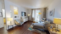 Located at 718 Old San Francisco Rd in Sunnyvale, California, this single-floor residence offers a well-appointed layout designed for comfortable living. The living room is a welcoming space featuring rich hardwood flooring, crisp white walls, and a sliding glass door that opens to an outdoor deck, filling the room with natural light and offering pleasant outdoor views. A wall-mounted TV and stylish furnishings complete the area's modern, mid-century-inspired aesthetic.

The galley-style kitchen is efficiently designed with warm honey-toned cabinetry, dark granite countertops, tile flooring, and a full suite of stainless steel appliances including a range, microwave, dishwasher, and refrigerator. The space flows seamlessly into the rest of the unit.

Two well-sized bedrooms provide comfortable retreats. The primary bedroom features plush carpeting, a ceiling fan, and generous natural light from a large window. The second bedroom also offers carpeted flooring, wall-mounted shelving, and a bright window outlook. Both bathrooms are finished with granite-topped vanities, warm wood cabinetry, and large mirrors, with one featuring a shower-tub combination. Throughout the residence, the cohesive design and quality finishes create a bright, functional, and inviting atmosphere.