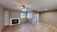 This 620 square foot, single-story apartment in Chula Vista offers a thoughtful layout maximizing its compact space. The living area is the heart of the home, featuring a fireplace with a white mantle, built-in shelving, and a ceiling fan for comfort. Wood-style flooring extends throughout the main living spaces, adding warmth and durability.

The kitchen, while compact, is efficiently designed with white cabinetry, a full-size range, and ample counter space. A sliding glass door in the living area leads to a private patio, bringing in natural light and offering outdoor views. The bedroom, measuring 160 square feet, includes carpeting and a ceiling fan for added comfort.

The bathroom is updated with a shower/tub combination, white tile surround, and a vanity with storage. The apartment's neutral color palette provides a blank canvas for personal style. With its mix of practical amenities and comfortable living spaces, this apartment offers a cozy home in a convenient Chula Vista location.