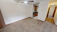 This well-designed apartment offers 860 square feet of living space on a single floor. The layout features two bedrooms, including a spacious primary bedroom of 160 square feet, and one bathroom. The kitchen is a highlight, boasting modern appliances, ample wood cabinetry, and sleek granite countertops. It's equipped with a double sink, stove, refrigerator, and built-in microwave.

The living areas are comfortably carpeted, creating a cozy atmosphere throughout. Large windows in the bedrooms and living room allow for natural light, while a sliding glass door in the main living area leads to an outdoor space. Storage is plentiful, with a walk-in closet in the primary bedroom and additional closet space in the second bedroom.

The bathroom is functional and clean, featuring a tub-shower combination, a single vanity, and tiled flooring. The apartment's neutral color palette, dominated by whites and light tones, provides a blank canvas for personalization. A ceiling fan in the living area aids in air circulation. The property is located at 7742 Radcliffe Drive Apt. F, Madison, WI, offering a comfortable living space in a convenient location.