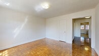 Located at 809 Juniper St in Takoma Park, MD, this two-bedroom, one-bathroom unit offers a well-organized single-floor layout that makes efficient use of its cozy footprint. Throughout the home, warm-toned parquet wood flooring adds timeless character and a polished finish that reflects natural light beautifully.

The living area greets you with two large multi-pane windows that flood the room with natural light, complemented by a classic cast-iron radiator that adds both warmth and vintage charm. The spacious primary bedroom continues the parquet flooring theme and features its own windows, providing pleasant natural light and views of the surrounding neighborhood. The second bedroom is equally well-proportioned and bright.

The bathroom is clean and classically appointed, featuring white subway tile walls, a full soaking tub with shower, a pedestal sink, and a charming mosaic-tile floor in a traditional basket-weave pattern. A sizable window brings in natural light, enhancing the airy feel of the space.

A compact kitchen and two hallways connect the rooms efficiently, ensuring a smooth flow throughout. With its classic architectural details, natural light, and warm parquet floors, this Takoma Park unit offers a comfortable and characterful living experience.