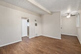 Located at 363 Palm Avenue in Imperial Beach, CA, this single-floor, one-bedroom, one-bathroom unit offers a efficiently designed layout across a compact but functional footprint. The living room welcomes you with warm hardwood-style flooring, distinctive exposed beam ceilings with a shiplap-style finish, and vertical blinds flanking a front entry door that allows natural light to filter in. The galley-style kitchen is thoughtfully arranged with white cabinetry, granite-look countertops, a gas range, refrigerator, and a single-basin sink — providing all essential amenities in a streamlined space. A hallway connects the main living areas to the private bedroom and bathroom. The bedroom features plush carpeting, exposed beam ceilings, a large window with vertical blinds that fills the room with natural light, and mirrored sliding closet doors that enhance the sense of space. The full bathroom includes a single-vanity with oak cabinetry, a white countertop, and a tub-shower combination with full white tile surround and a window for ventilation. Neutral tones and consistent architectural detailing throughout lend the space a clean, cohesive feel well-suited to comfortable everyday living in the Southern California coastal community of Imperial Beach.
