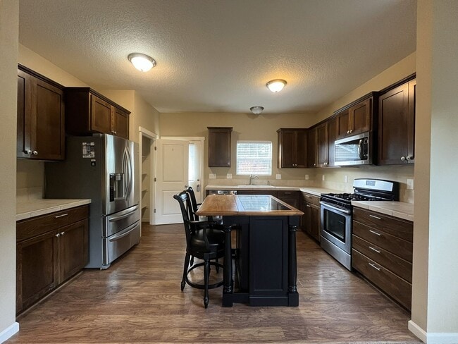 Building Photo - Light-Filled Home Featuring Island Kitchen, Fireplace & Two-Car Garage