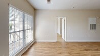 Located at 120 Chamberlain Dr in Asheville, NC, this single-floor, one-bedroom, one-bathroom residence offers a well-organized layout designed for comfortable everyday living. Light wood-style flooring runs consistently throughout the home, creating a cohesive and clean aesthetic in every room.

The combined kitchen and living area forms the heart of the unit. The kitchen is outfitted with warm honey-toned cabinetry, dark granite-style countertops, and a full suite of black appliances including a refrigerator, electric range, microwave, and dishwasher. A peninsula counter extends into the space, providing additional prep area and a natural division between the kitchen and living zone. The living area benefits from a private entrance door with a sidelite window, allowing natural light to filter in.

The spacious primary bedroom features a ceiling fan with light fixture and a sizable window with blinds that brings in natural greenery views from outside. A dedicated closet provides organized storage.

The bathroom is finished with white cabinetry, a wide vanity with a large mirror illuminated by a multi-bulb light bar, and a full soaking tub with shower. The neutral, warm beige tones found throughout the residence contribute to a calm and inviting overall ambiance.