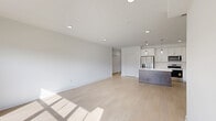 Located at 31601 Gabby Ct in Chesterfield, MI, this thoughtfully designed single-floor, 2-bedroom, 2-bathroom home offers a clean, modern aesthetic throughout. Light wood-tone flooring flows seamlessly across the entire space, creating a bright and cohesive feel.

The open-concept living, dining, and kitchen area serves as the heart of the home. The kitchen is well-appointed with crisp white cabinetry, marble-look quartz countertops and backsplash, stainless steel appliances including a refrigerator with ice maker, range, microwave, and dishwasher, complemented by sleek pendant lighting over the island. Recessed lighting and large windows flood the living area with natural light and offer pleasant views of the surrounding greenery.

Both bedrooms are bright and well-proportioned, each featuring large windows that frame outdoor lawn views, providing a serene atmosphere. The primary bedroom includes ample closet space, supported by a total of six closets throughout the home.

The two bathrooms offer distinct configurations: one features a full tub/shower combo, while the other includes a walk-in glass-door shower with a white vanity and quartz countertop. A dedicated utility room houses a stacked Samsung washer and dryer alongside the HVAC system, adding practical functionality to the layout.
