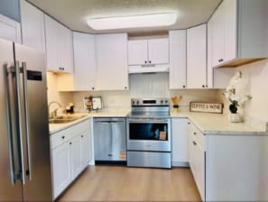Kitchen with new stainless steel appliances. - 755 S Alton Way