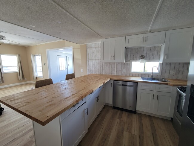 Brand new cabinets and butcher block countertops. - 9065 48th Ave N