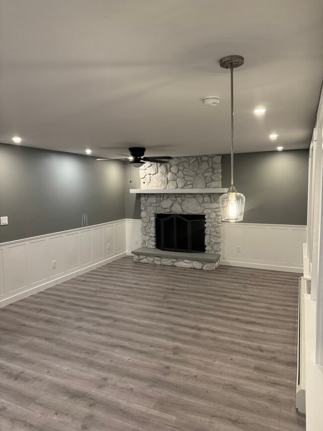 Living area with aesthetic stone fireplace - 25 Maple St
