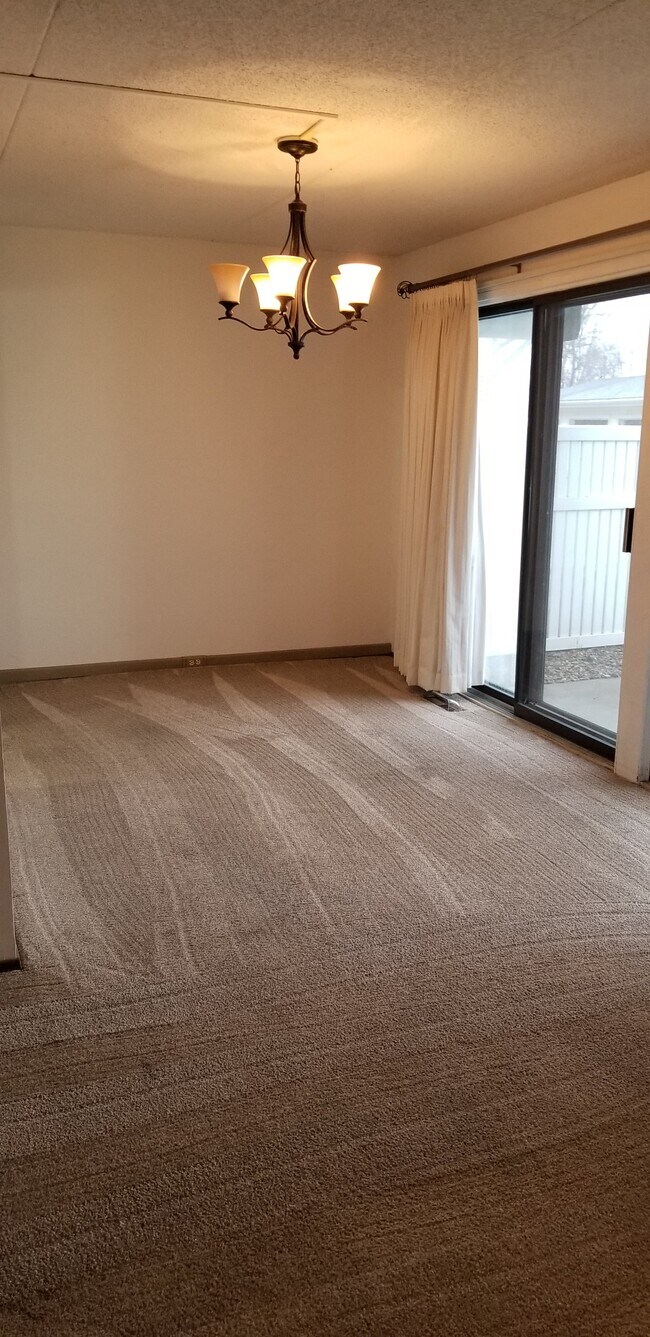 Dining area with view through sliding glass doors - 2955 Bowling St SW
