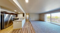 Located at 13105 21st Dr SE in Everett, WA, this single-floor, three-bedroom, two-bathroom home offers a well-designed layout that balances comfort and functionality. The open-concept kitchen and living area serves as the heart of the home, where light hardwood-style flooring transitions seamlessly from the kitchen into the carpeted living space. The kitchen is equipped with stainless steel appliances — including a full-size refrigerator, electric range, and over-the-range microwave — complemented by dark espresso cabinetry and a light-toned countertop with an extended breakfast bar. An in-unit laundry area is conveniently accessible from the kitchen. The spacious living room features plush carpet, neutral walls, and a sliding glass door that opens to a private balcony with outdoor views. Each of the three bedrooms offers carpeted floors, ample natural light, and neutral tones, with the primary bedroom providing a generous walk-in closet with wire shelving. The two bathrooms are finished with stone-look tile flooring and dark wood vanities. Recessed lighting throughout adds a modern touch to this clean, move-in-ready home.