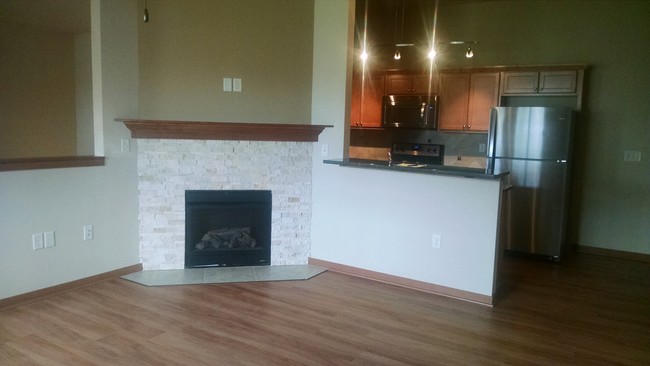 Living room has gas fireplace with wood style flooring - Hillstone Apartments