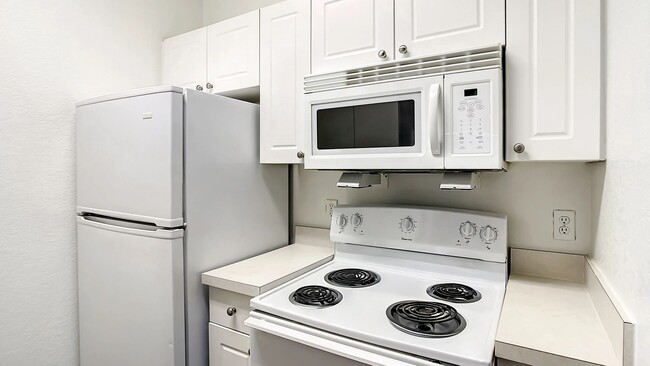 Enjoy culinary comfort in your fully equipped classic kitchen complete with ample cabinetry and all the appliances you've come to rely on, including a dishwasher! - Charleston Cay