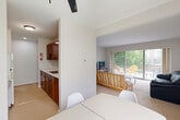 Located at 1313 S State St in Ann Arbor, MI, this two-bedroom, one-bathroom unit offers a practical and comfortable layout across a single floor. The bright living room is a standout feature, highlighted by large sliding glass doors that open onto a private balcony overlooking mature trees and the surrounding neighborhood — an ideal spot for outdoor relaxation. The space is carpeted throughout the living areas and bedrooms, lending a warm and quiet feel.

The kitchen is efficiently designed with rich wood-toned cabinetry and a functional layout, flowing naturally into the adjacent dining area, which benefits from a window with neighborhood views. A built-in shelving unit adds both character and practical storage to the living space.

Both bedrooms are well-proportioned and carpeted, each featuring built-in closets with sliding doors. The primary bedroom is generously sized with a window that brings in natural light. The second bedroom also includes closet storage and easy access to the shared hallway. The unit includes a total of three closets, providing excellent storage throughout.

The full bathroom features a soaking tub and shower combination, accented by a distinctive mosaic tile surround in warm cream and earth tones, adding a decorative touch to an otherwise clean, neutral palette. A hallway connects all rooms, contributing to the unit's functional flow.