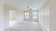 Located at 5960 Siegen Ln in Baton Rouge, Louisiana, this single-floor residence offers a well-organized layout with comfortable living spaces throughout. The spacious living room is highlighted by crown molding, a ceiling fan with light kit, and multiple large windows dressed with vertical blinds that allow generous natural light to fill the room. Plush wall-to-wall carpeting extends through the living area and into each bedroom, providing a warm and cohesive feel.

The bedrooms are generously proportioned, each featuring ceiling fans, neutral-toned walls, and large windows that offer views of the surrounding greenery. The layout provides a comfortable sense of openness in each room.

The kitchen is equipped with warm oak cabinetry, light-toned countertops, and black appliances including a range and over-the-range microwave. Wood-look flooring runs through the kitchen and connects to a dedicated laundry area nearby, adding practicality to the space.

The bathrooms feature oak cabinetry with ample storage, soaking tubs with shower combinations, and wood-look flooring that complements the warm tones found throughout the unit. A front entry door with sidelight windows welcomes natural light into the entryway, which opens directly into the broad living area. Overall, the space presents a clean, neutral palette well-suited for a variety of lifestyles.