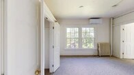 Located at 509 Wyckoff Rd in the charming village of Cayuga Heights, NY, this 2-bedroom, 1-bathroom unit offers a practical and comfortable single-floor layout. The space is finished throughout with soft carpet flooring and bright, neutral wall tones that contribute to a clean and welcoming atmosphere.

The spacious primary bedroom is generously sized and features large multi-pane windows that frame lush, leafy tree views, flooding the room with natural light. A wall-mounted mini-split air conditioning unit and a classic cast-iron radiator provide year-round climate control. An additional bedroom offers its own closet with a built-in rod and shelf for convenient storage.

The kitchen area is efficiently designed with white cabinetry, a double-basin sink, a white electric range, and an over-the-range microwave. Notably, an open double closet adjacent to the kitchen provides extra storage capacity. The unit includes a total of three closets throughout, ensuring ample organization options.

The bathroom is straightforward and functional, featuring tile flooring, a full tub-shower combination with a clean white surround, and a cast-iron radiator. The unit's layout, as seen in the dollhouse view, flows logically from the main living areas to the private spaces, making efficient use of the overall footprint.