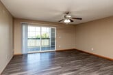 Located at 3205 Samuel Ct SW in Cedar Rapids, Iowa, this well-appointed 2-bedroom, 2-bathroom single-floor home offers a comfortable and functional layout. The combined kitchen and living area serves as the heart of the home, featuring durable hardwood-style flooring throughout. The kitchen is equipped with warm oak cabinetry, ample counter space, recessed lighting, and includes a dishwasher, stainless steel range, and refrigerator. The spacious living room is bathed in natural light through large sliding glass doors that open onto a private balcony overlooking a green outdoor view, complemented by a ceiling fan and textured ceiling. The generously sized primary bedroom includes plush carpeting, a ceiling fan, a dedicated closet, and a private en-suite bathroom featuring a walk-in shower. The second bedroom also offers comfortable carpeting and ample space. The second full bathroom includes a tub-shower combo, an oak vanity, and hardwood-style flooring. Two closets provide additional storage throughout the home. Neutral warm tones, wood-trimmed doors and baseboards, and consistent finishes across each room contribute to a cohesive and inviting ambiance throughout this well-maintained home.