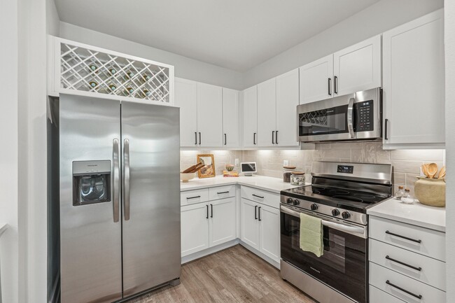 Kitchen with Quartz Countertop and Stainless Steel Appliances. - Forayna Watercolor Place