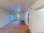 Located at 3429 Dawson St in Pittsburgh's Oakland neighborhood, this 3-bedroom, 1-bathroom unit offers a practical and functional single-floor layout. The open living area is generously sized, featuring wall-to-wall carpeting, clean white walls, and a sliding glass door that fills the space with natural light and provides access to an outdoor area. The kitchen is well-appointed with warm maple cabinetry, dark granite-style countertops, a stainless steel gas range, and hardwood-style flooring, offering a polished and functional workspace. Three carpeted bedrooms provide comfortable accommodations, with the primary bedroom standing out for its generous footprint and a wide built-in closet with sliding panel doors. Additional bedrooms are bright and simply finished, with one featuring its own sliding glass door access to the outdoors. The shared full bathroom includes a clean, all-white tub-shower combination with a handheld showerhead. A connecting hallway ties the layout together efficiently. Throughout the unit, neutral tones, consistent flooring materials, and an uncomplicated design create a clean, move-in-ready atmosphere suitable for a variety of living arrangements.