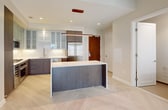 This penthouse apartment, located at 1 Canal in Boston, offers a sophisticated urban living experience within its 790 square feet. The space is efficiently designed with one bedroom, measuring 160 square feet, and two full bathrooms. The open-concept layout seamlessly integrates the kitchen and living room, creating a spacious feel.

The gourmet kitchen is a standout feature, boasting sleek dark cabinetry, stainless steel appliances, and a large center island. Glass-fronted upper cabinets and under-cabinet lighting add a touch of elegance. The living area is bathed in natural light from large windows, offering picturesque city views.

The bedroom, while compact, is well-appointed with a large window and ample closet space. The bathrooms are modern and luxurious, featuring double vanities, large mirrors with LED lighting, and glass-enclosed showers.

Throughout the apartment, light-toned wood flooring creates a cohesive and contemporary look. The unit also includes a walk-in closet with custom built-ins, providing abundant storage.

High ceilings and recessed lighting contribute to the airy ambiance, while the neutral color palette allows for personalization. This penthouse represents the epitome of modern city living, combining style, functionality, and breathtaking views in a prime Boston location.