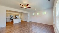 Located at 707 E Second Ave SW in Rome, GA, this well-appointed two-story home offers 3 bedrooms and 4 bathrooms across two thoughtfully designed floors. The main level features an open-concept layout where the living room flows seamlessly into the kitchen, creating an inviting communal space. The kitchen is equipped with granite countertops, gray shaker-style cabinetry, stainless steel appliances including a refrigerator, range, microwave, and dishwasher, and a central island with bar seating. Durable hardwood-style flooring and ceiling fans with lighting add to the comfortable atmosphere throughout the main living areas. A dedicated dining space, entrance, patio, laundry room, and an attached garage with an automatic opener complete the ground floor. Upstairs, the primary bedroom provides a generous retreat with plush carpeting, a ceiling fan, and access to multiple closets. The en-suite primary bathroom features a dual-sink granite vanity and a glass-enclosed walk-in shower. Additional bedrooms are well-sized with ceiling fans and ample closet space. Hallways connect the upper-level rooms efficiently, and four full bathrooms ensure convenience for residents and guests alike. The home's clean, neutral palette and modern finishes create a bright, move-in-ready environment throughout.
