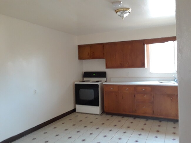 Bright open kitchen with new range - 111 1st Ave W