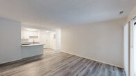 Located at 120 Montrose West Ave in Copley, Ohio, this one-bedroom, two-bathroom residence offers a thoughtfully arranged single-floor layout. The living room serves as the heart of the home, featuring a tile-surround fireplace, light wood-style flooring, a textured ceiling, and a window that draws in natural light, creating a bright and welcoming atmosphere. The combined dining and kitchen area is well-equipped with gray cabinetry, dark granite countertops, tile flooring, and a full suite of stainless steel appliances including a refrigerator, dishwasher, and range. The spacious primary bedroom is bathed in natural light from a large window and continues the light wood-style flooring found throughout the home. Both bathrooms are finished with granite countertops, undermount sinks, and wood-framed mirrors. One bathroom provides access to two closets — a walk-in closet with built-in shelving and a secondary closet — offering generous storage. A hallway connects the spaces efficiently within the compact yet functional footprint. The neutral color palette and consistent finishes throughout lend the space a clean, move-in ready feel.