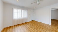 Located at 1304 McKie Dr in Austin, TX, this single-story, 3-bedroom, 2-bathroom home offers a clean, modern interior with a bright and cohesive design throughout. Warm-toned luxury vinyl plank flooring runs through the main living areas and bedrooms, complemented by crisp white walls and vertical blinds that filter natural light into every room.

The kitchen is well-appointed with white shaker-style cabinetry, light countertops, a subway tile backsplash, and a full suite of stainless steel appliances including a range, microwave, dishwasher, and side-by-side refrigerator. A skylight above the kitchen adds a bright, airy quality to the space.

The combined kitchen and living area creates an open, functional layout ideal for everyday living. Each bedroom features a ceiling fan with light fixture and vertical blinds over sizable windows, allowing for natural light and ventilation. The primary bedroom includes access to a dedicated closet with built-in shelving.

Both bathrooms are finished with neutral tile wainscoting, white vanities with dark-accented faucets, framed mirrors, and overhead cabinetry for storage. One bathroom includes a bathtub. The home's consistent, updated finishes and efficient layout make it a practical and comfortable residence in Austin.