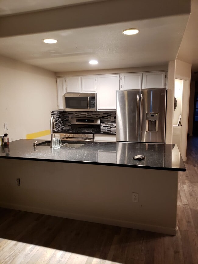 Kitchen open and updated counter and backsplash. Gas stove. Has dishwasher. - 813 Gabriel Ct