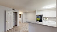 Located at Village Center Blvd in Fairburn, GA, this single-story, one-bedroom, one-bathroom residence offers a thoughtfully designed layout that maximizes comfort and functionality. The kitchen is a standout feature, showcasing white cabinetry, granite-style countertops, a tile backsplash, and black appliances including a refrigerator, electric range, and dishwasher. A peninsula counter extends the workspace and creates a natural divide between the kitchen and the living area, which features light wood-style flooring throughout. Convenient in-unit laundry and a large open shelving closet are tucked just off the main living space, adding practical storage and everyday ease. The generously sized bedroom is carpeted for warmth and comfort, featuring dual windows that invite natural light and outdoor views, complemented by a ceiling fan for year-round comfort. The full bathroom is clean and bright, with wood-style flooring, a single vanity with ample counter space, a toilet, and a full soaking tub with shower. Neutral tones and consistent finishes throughout the space create a cohesive, move-in-ready atmosphere suited for comfortable everyday living.
