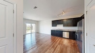 Located on Herrington Blvd in Geneva, IL, this 1-bedroom, 1-bathroom residence offers a thoughtfully designed single-floor layout that maximizes both function and comfort. The kitchen is a standout feature, showcasing rich dark cabinetry, granite countertops, warm hardwood flooring, and a full suite of stainless steel appliances including a gas range, built-in microwave, dishwasher, and refrigerator. A track lighting fixture overhead provides excellent task illumination throughout the space.

The spacious bedroom is carpeted for comfort and features a double window that fills the room with natural light, creating a bright and airy atmosphere. An adjacent walk-in closet offers generous storage with wire shelving systems spanning the full width of the space.

The bathroom continues the design consistency of the home, with matching dark cabinetry, granite countertops, a large mirror, and hardwood-style flooring. Clean white walls and chrome fixtures complete the polished look.

A private balcony extends the living space outdoors, offering a pleasant view of the well-maintained community landscape, mature trees, and manicured greenery — ideal for relaxing or enjoying the fresh suburban surroundings of Geneva, Illinois.