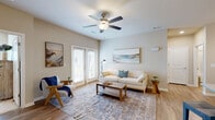 Located at 311 Hope Bird Lane in Longs, SC, this single-story 2-bedroom, 2-bathroom home offers a thoughtfully designed layout that maximizes comfort and functionality. The open-concept living room is bright and welcoming, featuring warm wood-look flooring, a ceiling fan with light fixture, and French doors that invite natural light from outside. The space flows seamlessly from the entry hallway into the main living area, creating an airy, connected feel throughout.

The galley-style kitchen is well-equipped with white shaker cabinetry, granite countertops, stainless steel appliances including a refrigerator, electric range, microwave, and dishwasher, along with pendant lighting above the counter — combining style with practicality.

Both bedrooms are carpeted and generously sized, each featuring ceiling fans and bright windows with blinds. The primary bedroom offers a comfortable, restful atmosphere with ample closet space. The two bathrooms are finished with granite-topped vanities, wood-look flooring, and large mirrors, providing a clean and modern aesthetic.

A dedicated laundry room with full-size washer and dryer hookups and built-in shelving adds everyday convenience. Neutral tones and consistent finishes throughout lend the home a cohesive, move-in-ready appeal.
