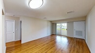 Located at 45 Euclid Ave in Hackensack, NJ, this well-appointed one-bedroom, one-bathroom unit offers a thoughtfully designed single-floor layout with a clean, modern aesthetic throughout. Warm hardwood flooring flows seamlessly across the living room, bedroom, and kitchen, creating a cohesive and inviting atmosphere.

The spacious living room is a standout feature, anchored by a sliding glass door that fills the space with natural light and provides views of the surrounding greenery. The kitchen is equipped with rich dark wood cabinetry, granite-style countertops, and a full suite of stainless steel appliances — including a refrigerator, electric range, and built-in microwave — combining both style and functionality.

The generously sized primary bedroom accommodates a comfortable living arrangement and benefits from a large window that brings in additional natural light. A dedicated closet provides ample storage. The full bathroom is finished with a clean, white aesthetic and includes a shower/tub combination with a safety grab bar.

A hallway connects the rooms efficiently, contributing to the unit's practical flow. Throughout the space, bright white walls, updated fixtures, and consistent flooring choices give the unit a fresh, move-in-ready feel ideally suited for those seeking comfortable living in Hackensack.