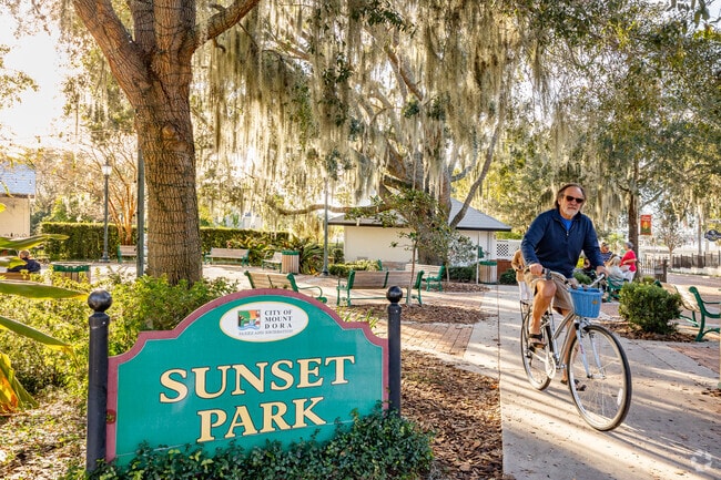 People walk and ride bikes through Sunset Park In Mount Dora.