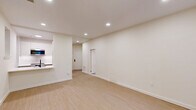 Located at 3500 Powelton Ave in Philadelphia's Powelton Village neighborhood, this thoughtfully designed one-bedroom, one-bathroom unit offers a clean, modern aesthetic throughout. Light wood-style flooring flows continuously across the entire space, complementing the crisp white walls and recessed lighting that brighten every room.

The open-concept kitchen and living area serves as the heart of the unit. The kitchen features white upper cabinetry, two-tone lower cabinets, a stainless steel range, built-in microwave, full-size stainless steel refrigerator, and a white quartz peninsula with an undermount sink and matte black faucet — ideal for both cooking and casual dining. The living area is generously proportioned, with multiple windows allowing natural light and neighborhood views.

The bedroom is a comfortable, well-sized room with two windows overlooking the surroundings and a dedicated closet. Two total closets provide practical storage throughout the unit.

The bathroom is finished with a light wood vanity with a white countertop, grey tile flooring, and a tub/shower combination featuring stacked rectangular subway tile and matte black fixtures, adding a contemporary touch.

A hallway connects the rooms efficiently, completing this well-laid-out, move-in-ready unit in a vibrant Philadelphia neighborhood.