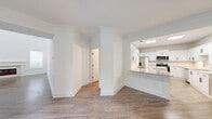 Located in Kennesaw, GA, this well-appointed two-story home offers a thoughtfully designed layout spread across two floors. The main level welcomes you through a dedicated entrance that flows into an open-concept living and dining area, finished with light wood-tone flooring and crisp white walls that create a bright, airy ambiance. The kitchen is a standout feature, boasting white shaker-style cabinetry with matte black hardware, quartz countertops, a central island, stainless steel appliances including a refrigerator and microwave, and skylight panels that flood the space with natural light. French doors on the main level open to a private patio, extending the living space outdoors. A dedicated laundry room houses a full-size Whirlpool washer and dryer. The oversized two-car garage offers a clean, epoxy-finished floor and ample overhead lighting. Upstairs, the primary bedroom is generously sized with soaring ceilings, a ceiling fan, plush carpet, and access to multiple closets with built-in wire shelving. The bathrooms are finished with neutral tile surrounds, white vanities, quartz countertops, and wood-look flooring. With five closets throughout, storage is abundant in this well-designed home.