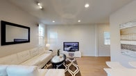 Located at 2453 Pizzaro Dr in Santa Maria, California, this two-story home offers a clean, modern aesthetic throughout. Light wood-style flooring flows seamlessly across both levels, complementing the neutral color palette and creating a warm, cohesive atmosphere.

The living room is generously sized, featuring recessed lighting, a track light fixture, and multiple windows with plantation-style shutters that invite ample natural light. The kitchen is well-appointed with white shaker cabinetry, light countertops, a stainless steel gas range, built-in microwave, and a large French-door refrigerator. Adjacent to the kitchen, the dining area is anchored by a statement pendant light and sliding glass doors that open directly to a fenced backyard patio.

Upstairs, the primary bedroom is notably spacious with tall ceilings, multiple windows, and direct access to an en-suite bathroom featuring a dual-sink vanity with white cabinetry, and a connected walk-in closet. A secondary full bathroom includes a double-sink vanity and a soaking tub with tile surround. Additional bedrooms offer comfortable proportions and natural light through blinds-fitted windows. A dedicated laundry room houses a full-size washer and dryer. The home combines functional design with a light, airy ambiance throughout.