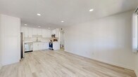 Located at 44150 35th St W in Lancaster, CA, this clean and modern 2-bedroom, 2-bathroom unit offers a well-designed single-floor layout filled with bright, neutral tones throughout. The open-concept living and kitchen area serves as the heart of the unit, featuring light wood-style luxury vinyl flooring, recessed lighting, and crisp white walls that create an airy, welcoming atmosphere. The kitchen is well-appointed with white shaker-style cabinetry extending to the ceiling for generous storage, stainless steel appliances including a refrigerator, dishwasher, microwave, and range, as well as a stainless steel sink and clean white countertops. The living area benefits from a window offering outdoor views and connects seamlessly to a private balcony. The spacious primary bedroom provides a comfortable retreat, while the second bedroom is equally bright and versatile. Three closets distributed throughout the unit ensure ample storage. Both bathrooms are finished in a clean, minimal style, with one featuring a full tub-shower combination. A hallway connects the private areas of the unit efficiently. The consistent light flooring and white palette throughout lend the entire space a cohesive, modern feel.