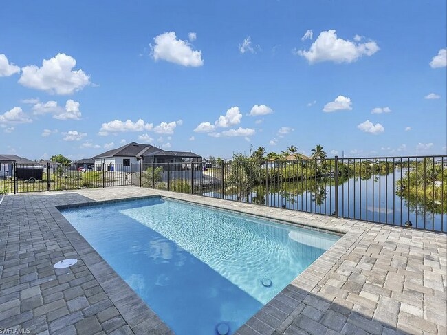 Photo - Almost New Construction Waterfront Home in NE Cape Featuring A Pool, Fenced Patio & More!