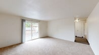 This single-floor, 3-bedroom, 1-bathroom residence offers a practical and well-organized layout. The living room is a comfortable, open area finished with plush wall-to-wall carpeting and features a sliding glass door that opens onto a private balcony with views of the surrounding neighborhood and mature trees, allowing natural light to fill the space.

Adjacent to the living room, the kitchen features stone-look countertops, white cabinetry, and durable wood-look flooring. A ceiling fan and a window overlooking the greenery enhance the dining area just off the kitchen.

Each of the three bedrooms is carpeted and equipped with baseboard heating. The bedrooms feature windows that bring in natural light and outdoor views of the surrounding trees and neighborhood. Two of the bedrooms are connected, offering flexible use as a primary suite or shared living arrangement. Two closets provide convenient storage throughout the unit.

The full bathroom is finished with wood-look flooring, a vanity with a stone-look countertop, and a full tub-shower combo with clean white tile surround. The overall color palette throughout is neutral and bright, with white walls creating a clean, move-in-ready ambiance.