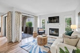 Located in Laguna Niguel, CA, this well-designed 2-bedroom, 2-bathroom single-floor home offers a comfortable and functional layout filled with natural light. The inviting living room serves as the heart of the home, showcasing wood-look flooring, a clean white fireplace with a wall-mounted TV above, and sliding glass doors that open to a private balcony with views of lush greenery. Multiple windows throughout keep the space bright and airy.

The kitchen features white shaker-style cabinetry, grey quartz-style countertops, and ample storage, making it both practical and visually clean. Equipped with a dishwasher, range, and microwave, it is well-suited for everyday cooking.

The primary bedroom offers a generous footprint with plush carpet, a large window for natural light, and a dedicated en-suite bathroom that includes a single vanity with white cabinetry and a shower-tub combination. The second bedroom is equally comfortable, with soft carpet and access to the second full bathroom, which also features a shower-tub combo and a grey-topped vanity. A hallway closet provides additional storage. Throughout, the neutral color palette and consistent wood-look flooring in common areas create a cohesive and welcoming ambiance.