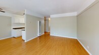 Located at 1225 Walnut St in Napa, CA, this well-appointed 2-bedroom, single-floor unit offers a comfortable and functional layout across a generously sized floor plan. The open-concept kitchen and living area serves as the heart of the home, featuring warm hardwood-style flooring throughout. The galley-style kitchen is equipped with white cabinetry, dark countertops, a coil-top electric range, and a built-in pantry, providing ample storage and prep space. The adjacent living room is bright and open, benefiting from natural light and a ceiling fan, with direct access to a private balcony overlooking a sparkling pool and mature trees — a serene outdoor retreat. The two bedrooms are carpeted for comfort and each include ceiling fans with light fixtures and generous closet space, including a sliding-door closet with built-in shelving and hanging rods in the primary bedroom. Neutral wall tones throughout the unit lend a clean, versatile aesthetic. A connecting hallway ties the living spaces and bedrooms together seamlessly. The overall ambiance is calm and practical, making this a well-rounded residential space in the heart of Napa.