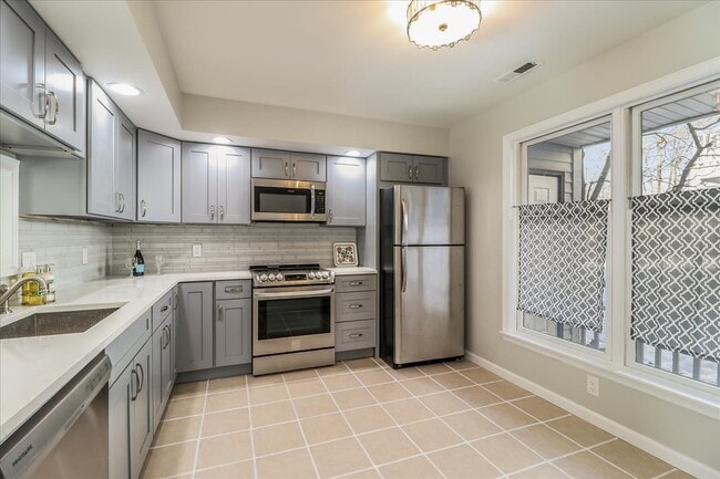Stunning clean kitchen with quartz tops and stainless steel appliances - 20 Raymond Plz