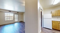 This single-floor, 4-bedroom, 2-bathroom unit offers a practical and well-organized layout designed to maximize functionality. The living room features rich, dark wood-style flooring and a glass door that invites natural light and provides outdoor access, creating an open and airy atmosphere. Adjacent to the living area, the kitchen is equipped with warm wood cabinetry, a white refrigerator, dishwasher, and range, all set on matching wood-style flooring. A structural column separates the kitchen from the living space, adding architectural definition to the open layout. The bedrooms offer a mix of flooring options — some feature the same durable wood-style planks, while others are finished with soft carpeting. The spacious primary bedroom is notable for its large window framing a pleasant outdoor view of greenery. The two bathrooms are well-appointed; one includes a tiled walk-in shower with grab bars and a handheld showerhead, while the other features a combination tub/shower, wood-vanity with a white countertop, and wood-style flooring. A connecting hallway ties the rooms together efficiently. The unit's neutral color palette and clean finishes provide a versatile, move-in-ready aesthetic throughout.