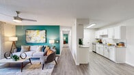 This thoughtfully designed 2-bedroom, 2-bathroom residence offers a comfortable and cohesive single-floor layout that maximizes everyday livability. The open-concept living, dining, and kitchen area serves as the heart of the home, anchored by a bold teal accent wall, wood-look LVP flooring, and a ceiling fan overhead. The kitchen features crisp white shaker cabinets, granite countertops, a classic subway tile backsplash, and stainless steel appliances, with a peninsula that opens naturally to the dining and living spaces. A dedicated dining nook provides an intimate setting for meals.

A long hallway connects the living areas to both bedrooms, each finished with plush carpeting. The generously sized primary bedroom features a matching teal accent wall, a ceiling fan, and a large window allowing natural light to fill the room. It also includes a spacious walk-in closet with built-in wire shelving. The second bedroom is well-proportioned with its own closet access. Both bathrooms are appointed with granite-topped vanities and tub-shower combinations. Throughout, textured ceilings and clean white walls create a bright, cohesive aesthetic that balances modern updates with comfortable, functional design.