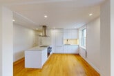 Located at 5530 Ch De La Côte-Saint-Luc in Montréal, this well-appointed 3-bedroom, 2-bathroom unit offers a clean, modern aesthetic across a thoughtfully designed single-floor layout. Warm honey-toned hardwood flooring runs throughout the space, unifying each room with a consistent, inviting character.

The bedrooms are bright and well-proportioned, each featuring large windows that invite generous natural light and offer views of the surrounding tree-lined neighbourhood. The primary bedroom includes direct access to an ensuite bathroom, while a built-in closet with sliding doors adds practical storage. Additional bedrooms are versatile, each with their own window framing pleasant outdoor views.

The two bathrooms are finished with neutral large-format tiles in muted earthy tones. The main bathroom features a full tub-shower combination enclosed by glass panels, recessed lighting, and a window for natural ventilation. The second bathroom is equally well-appointed with coordinating tile work.

A central hallway connects the rooms efficiently, lined with recessed lighting and crisp white walls that reinforce the unit's clean, contemporary feel. The kitchen, visible in the dollhouse view, features a central island with a built-in sink. Throughout, the design emphasizes simplicity, functionality, and bright, airy living.