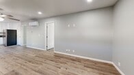 Located at 4040 E Dakota Ave in Fresno, CA, this thoughtfully updated single-story home offers two bedrooms and two bathrooms within a efficiently designed floor plan. Light-toned luxury vinyl plank flooring runs consistently throughout the entire space, creating a cohesive and modern aesthetic.

The open-concept living and kitchen area serves as the heart of the home. The kitchen is well-appointed with crisp white shaker cabinetry, dark countertops, a stainless steel sink, and a full suite of stainless steel appliances including a gas range, over-the-range microwave, and refrigerator. A window above the counter brings in natural light and provides a view of the exterior. The adjacent living area features recessed lighting and a ceiling fan, with a wall-mounted mini-split unit providing efficient climate control.

Both bedrooms are comfortably sized, with the primary bedroom offering its own mini-split unit and ample closet space. The second bedroom includes a ceiling fan and a window that fills the room with natural light. Three closets are distributed throughout the home for generous storage.

The bathrooms are finished to a high standard, with one featuring a glass-enclosed corner shower adorned with marble-style tile, a stylish vanity, and brushed nickel fixtures. The clean, neutral color palette of soft gray walls and white trim carries throughout the entire home, creating a bright and welcoming atmosphere.