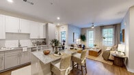 This thoughtfully designed 2-bedroom, 2-bathroom single-floor residence offers a functional and stylish open-concept layout. The kitchen is a standout feature, equipped with stainless steel appliances, white and gray shaker-style cabinetry, a white tile backsplash, and granite countertops that extend to a peninsula with bar seating — ideal for casual dining and entertaining. Wood-style flooring runs throughout the main living areas, adding warmth and cohesion to the space.

The living room is bright and welcoming, featuring a ceiling fan, large windows with natural light, and direct access to an outdoor area via a glass-paned door. The primary bedroom is a comfortable retreat with a ceiling fan, a large window, and a dedicated walk-in closet outfitted with wire shelving systems. The second bedroom is equally well-lit, featuring soft accent wall tones and ample natural light.

Both bathrooms are finished with granite-topped vanities, shaker-style cabinetry, and warm lighting. Two closets throughout the residence provide generous storage. The neutral color palette, consistent flooring, and modern finishes create a cohesive and move-in-ready living environment suited for a variety of lifestyles.